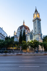 Retiro Park, Madrid, Spain. Crystal Palace, lake with swans, glass structure, architecture. Lake and temple on the horizon, fountains and decorated with colorful plants and flowers, family leisure.