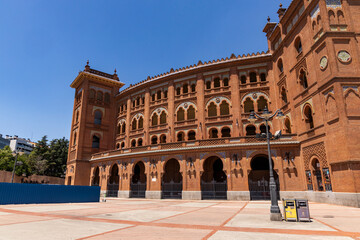 Fototapeta premium Las Ventas bullring, Madrid, Bull square. Plaza de toros. Events and traditions of Spain. Red sand under a burning sun. No people. Fight between matador and bull. Blood, passion, dance, celebration.