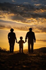 A family holds hands as the sun sets, capturing a moment of unity and connection