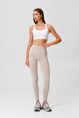 Fitness woman. Athletic girl on the gray background