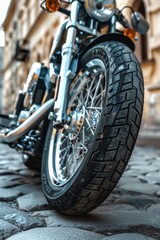 Obraz premium A motorcycle parked on a cobblestone street, great for urban or travel-themed compositions