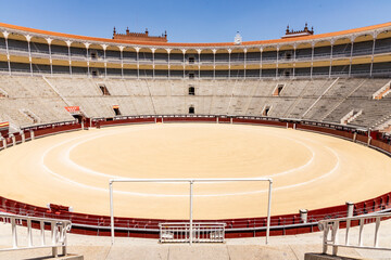 Las Ventas bullring, Madrid, Bull square. Plaza de toros. Events and traditions of Spain. Red sand under a burning sun. No people. Fight between matador and bull. Blood, passion, dance, celebration.