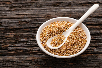 Amaranthus - Organic amaranth pops in the bowl and spoon. wooden background