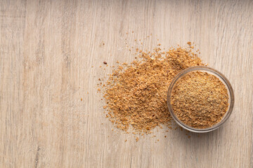 Soy fiber based powdered food in the bowl - wooden background