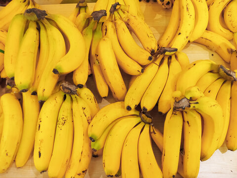 Bananas for sell in the supermarket. Yellow bananas in shelves of supermarket.