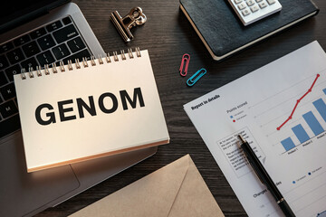 There is notebook with the word GENOM. It is as an eye-catching image.