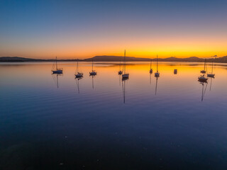 Aerial drone sunrise waterscape over the bay and boats