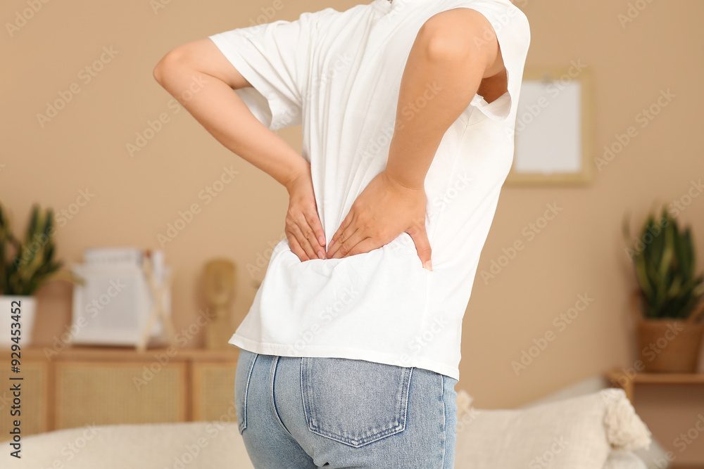 Canvas Prints Young woman suffering from back pain at home