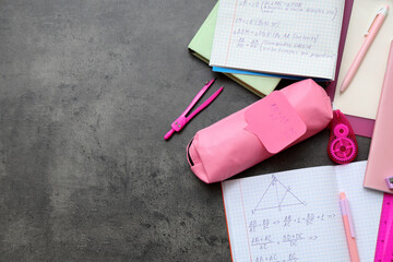 Copybooks with math formulas and bright stationery on dark background