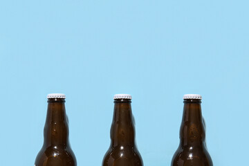 Bottles of cold beer on blue background
