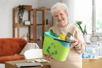 Senior woman with garbage bin at home. Waste sorting concept