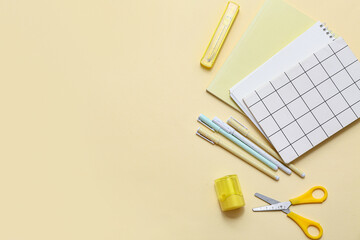 Set of stationery with notebooks on color background