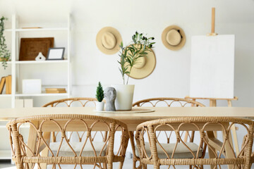 Plants with decor on dining table in room