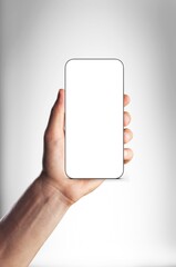 Human hand holding smart phone with a blank screen