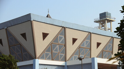 Close-up of a mosque's modern facade showcasing geometric patterns and minimalist design,...