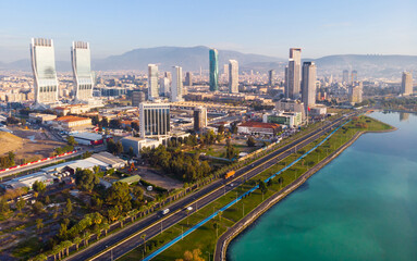 Scenic aerial view of modern cityscape of Izmir along shoreline of Aegean Sea on sunny winter day,...