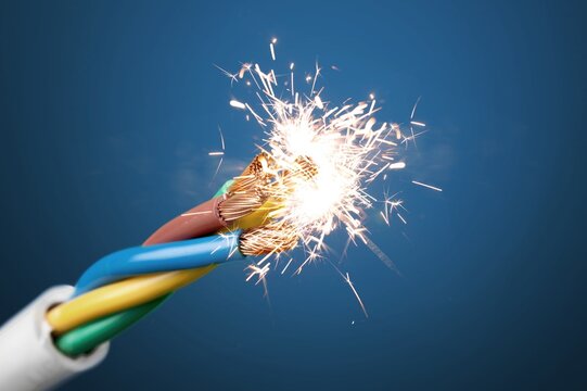 Sparks explosion at electrical cables, fire hazard concept