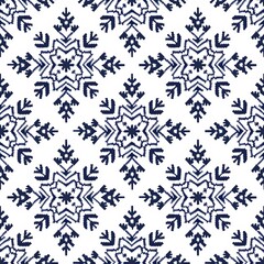 Seamless knitting pattern with blue snowflakes on white background. New Year and Christmas concept. Traditional Fair Isle style. Cozy winter design for print, banner, poster, paper, textile, fabric