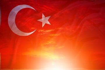 turkish flag on sunset background on clouds