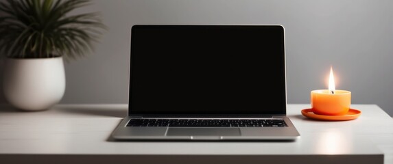 Laptop on a Desk with a Lit Candle