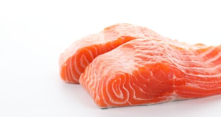 Pieces of fresh salmon on white background, closeup. Space for text