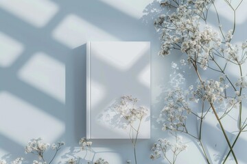 A white book sits on top of a white table, ready for reading