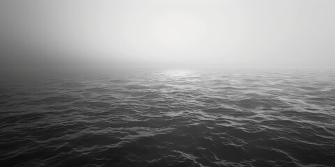 Obraz premium A black and white photograph of the ocean's calm waters and shore