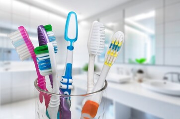 Plastic toothbrushes set in holder, on table indoors.