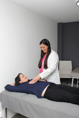 Female doctor, gynecologist specialist, treats and checks patient, teaching her breast cancer self-examination