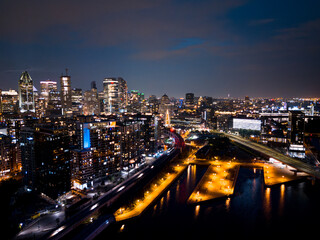 Fototapeta premium Montreal skyline illuminated at dusk and reflected in the water, Quebec, Canada