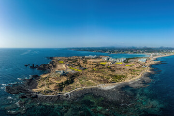 Seogwipo-si, Jeju-do, South Korea - March 12, 2022: Aerial view of Glass House on Seopjikoji Beach with volcanic rocks near the sea