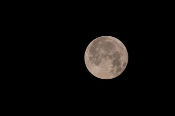 The moon surrounded by black sky.