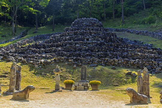 Hwagye-ri, Sancheong-gun, Gyeongsangnam-do, South Korea - May 3, 2022: Spring view of stone mound at Jeonguhyeong Royal Tombs of Galaggug Dynasty with tomestone and stone lanterns