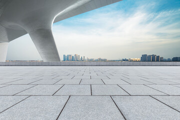 Empty square floor and city skyline with modern buildings.