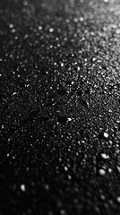 dark asphalt road surface, featuring a grey tarmac with visible imperfections, ideal for conveying themes of urban roads, travel, or infrastructure