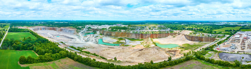 Aerial View of Quarry with Turquoise Pools and Lush Fields