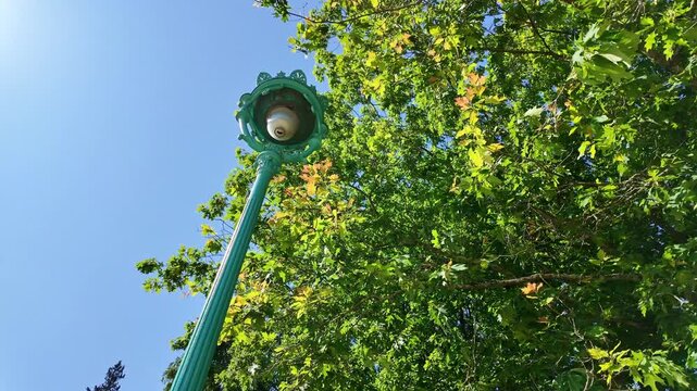 Ordinary street lamp and its environment at Thabor park in Rennes, France.