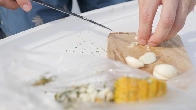 Cut and put garlic on corn