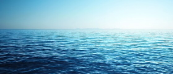 Obraz premium A tranquil blue ocean scene with soft waves and a clear sky