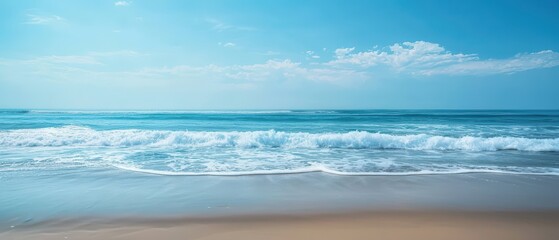 Obraz premium A tranquil blue ocean scene with soft waves and a clear sky