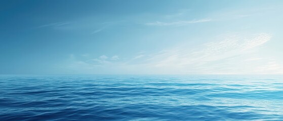 Obraz premium A tranquil blue ocean scene with soft waves and a clear sky
