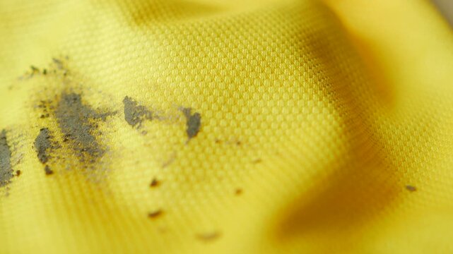  dirty mud stain on a yellow color cloth 