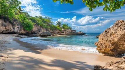 A serene beach scene with clear water, gentle waves, and lush greenery under a blue sky.