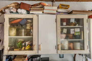 kitchen larder cabinet in pale cream full of various products for the kitchen