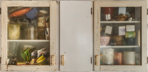 kitchen larder cabinet in pale cream full of various products for the kitchen