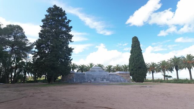 Walking in front of Memorial Badajoz Alcazaba, Spain - Orbiting shot