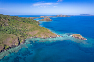 Aerial view above Scuba dive and snorkeling site coral reef beside tropical Island in Fiji	