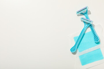 Shaving razors with wax strips on a light background