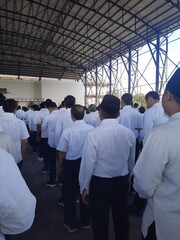photo of a flag ceremony person in a white uniform in Indonesia