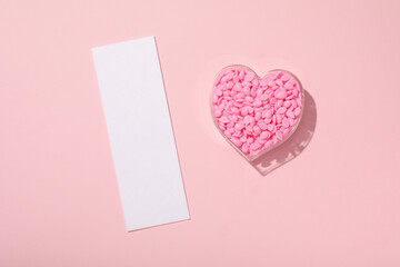 Wax granules for depilation laid out in the shape of a heart